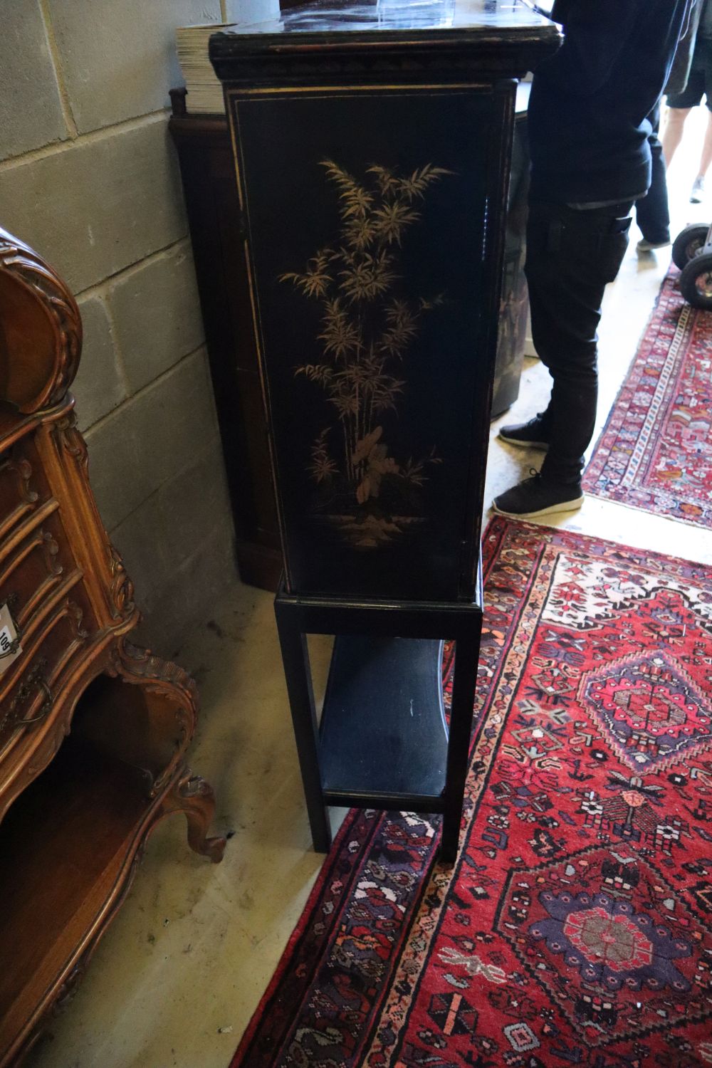 A 19th century chinoiserie cabinet on later ebonised stand, width 63cm, depth 27cm, height 130cm